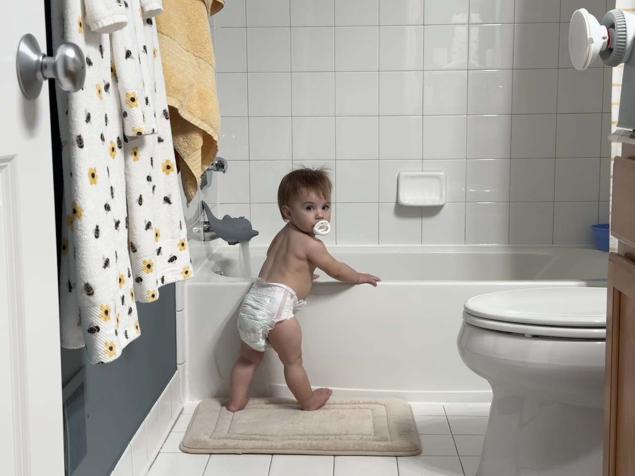 Zoe waiting for the bath water to fill the tub.