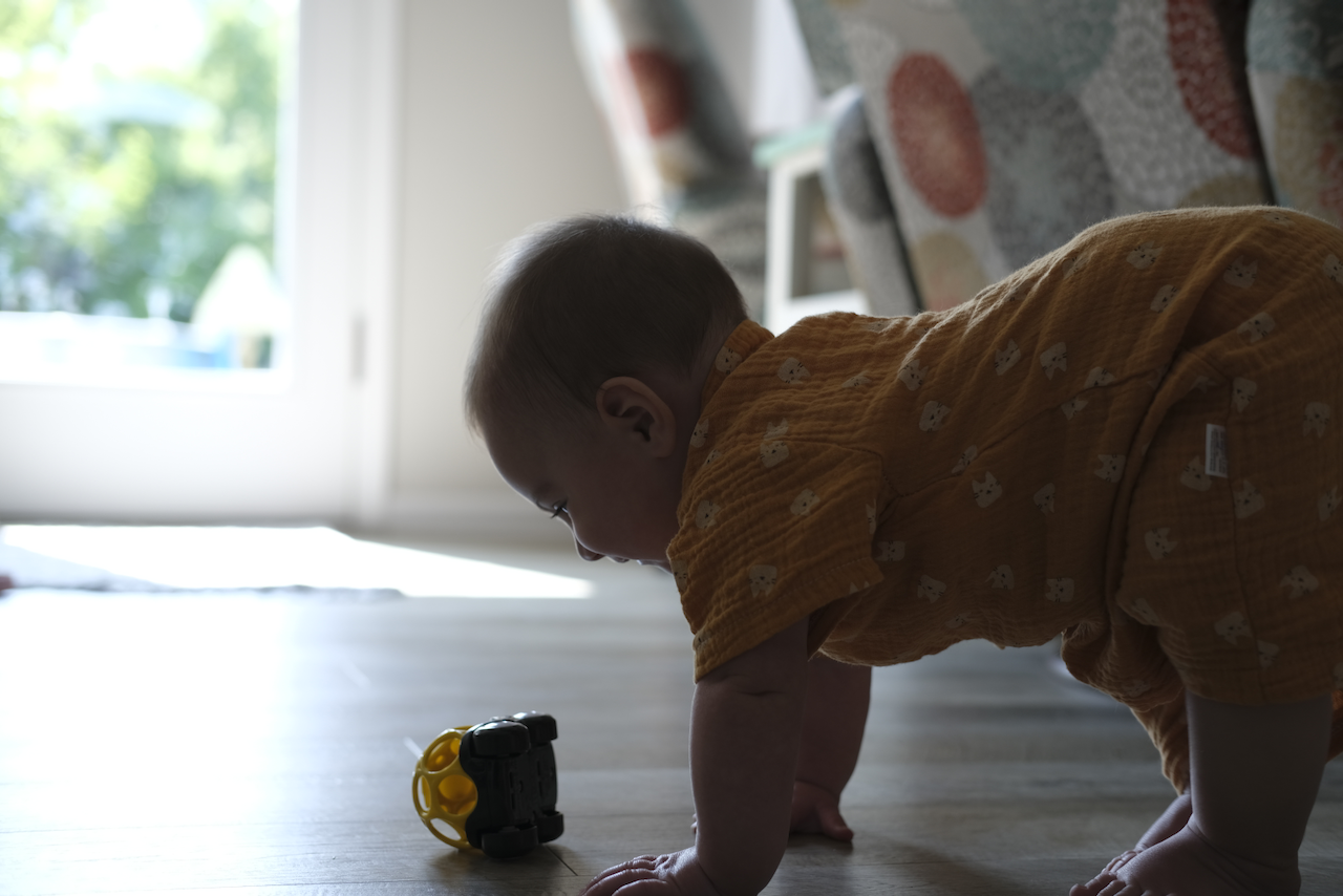 Zoe crawling to a toy car at grandmas.