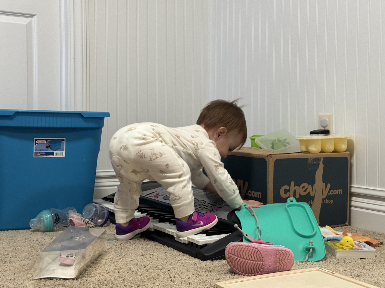Zoe standing on a keyboard with her cool shoes.