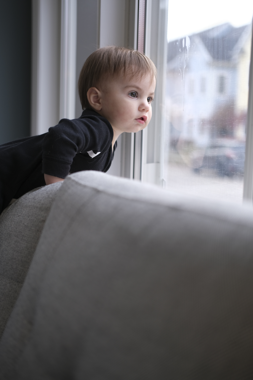 Zoe watching out the window for a friend to wave to.